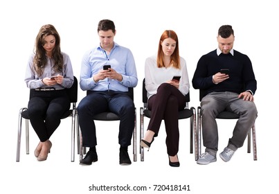 Group Of Multi Ethnic Business People Sitting On Chair Using Cell Phone Against White Background