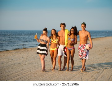 Group Of Multi Ethnic Friends Walking On A Beach