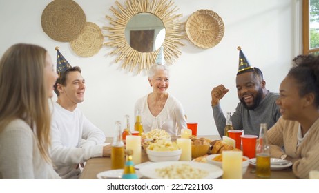 A group of multi ethnic. Portrait of Caucasian and African American black family, woman have a celebration dinner in party on holiday at home.People lifestyle. Reunion. - Shutterstock ID 2217221103
