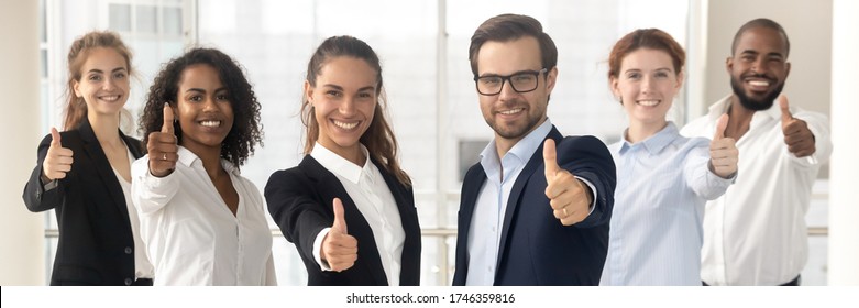 Group of multi ethnic staff standing in row smiling showing thumbs up hand gesture, concept of career success growth, best corporate service feedback. Horizontal photo banner for website header design - Powered by Shutterstock