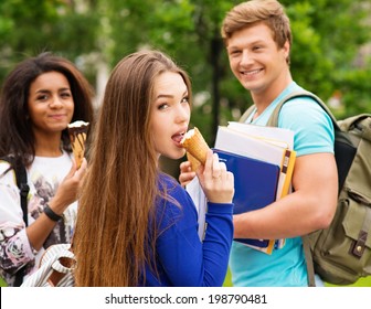 Group Of Multi Ethnic Students Eating Ice-cream Outdoors