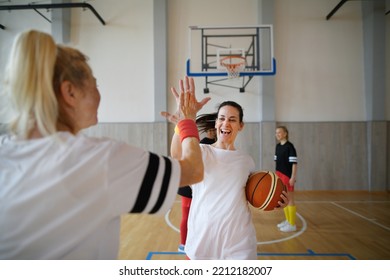 Group Of Multiaged Women, Sports Team Players, In Gym Celebrating Victory.