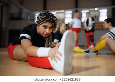 Group of multiaged women, sports team players. in gym stretching, warming up before match. - Powered by Shutterstock