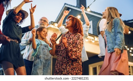 Group of Multicultural Diverse Friends and Relatives Having Fun and Dancing Together at a Garden Party Celebration. Beautiful and Handsome Young and Old People Having Fun. Slow Motion Footage.
