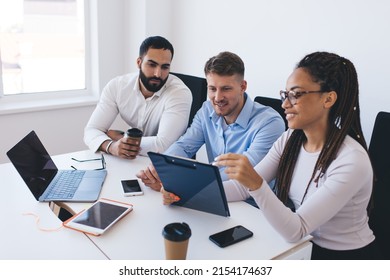 Group of multicultural employees discussing paper notes while analyzing report statistics on briefing meeting in office interior, young colleagues talking about trade exchange and CEO profession - Shutterstock ID 2154174637