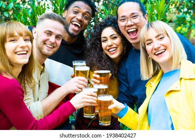 Group Of Multicultural Friends Drinking And Toasting Beer At Brewery Bar Restaurant - Happy People Having Fun At Rooftop Home Party - Vivid Color Filter