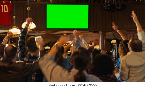 Group of Multicultural Friends Watching a Live Sports Match on TV with Green Screen Display in a Bar. Happy Fans Cheering and Shouting, Celebrating When Team Scores a Goal and Wins the Tournament. - Powered by Shutterstock