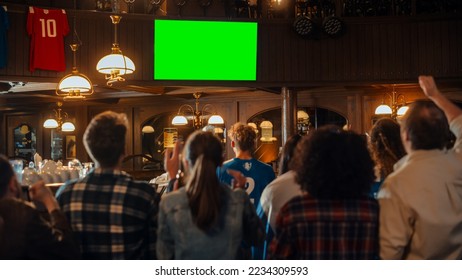 Group of Multicultural Friends Watching a Live Sports Match on TV with Green Screen Display in a Bar. Happy Fans Cheering and Shouting, Celebrating When Team Scores a Goal and Wins the Tournament. - Powered by Shutterstock