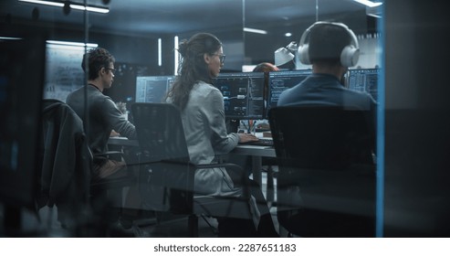 Group of Multicultural Men and Women Working in a Research Center, Collaborating and Discussing a Project, Using Computers to Write Advanced Software Code, Develop Artificial Intelligence Service - Powered by Shutterstock