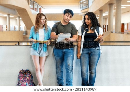 Group of multicultural university students discussing schoolwork, fostering teamwork in an educational setting