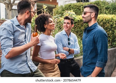 Group Of Multicultural Young People Hangout Drinking Beers And Talking Outdoors - Meeting Between Friends In The Park