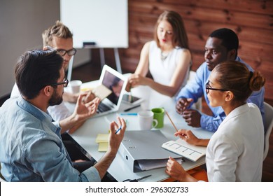 Group of multi-ethnic business partners discussing ideas - Shutterstock ID 296302733