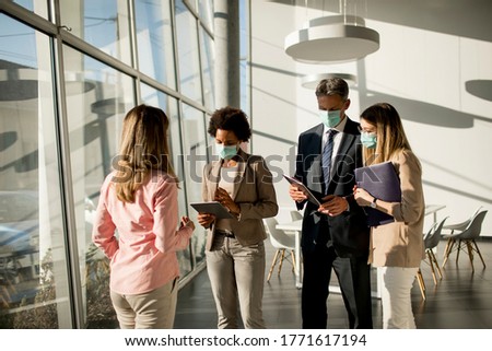 Group of multiethnic business people have a meeting and working in the office while wear mask as protection from corona virus