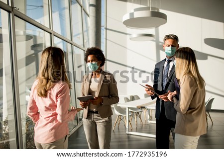 Group of multi-ethnic business people have a meeting and working in the office while wear masks as protection from corona virus