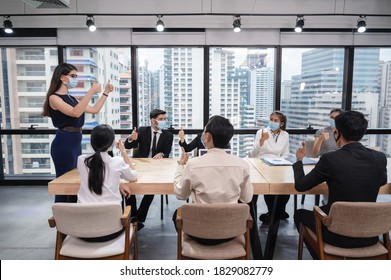 Group Of Multiethnic Business People Wearing Face Mask Showing Thumbs Up And Agree Of Business Agreement During The Meeting In New Normal Office While Pandemic Of Coronavirus, Covid 19