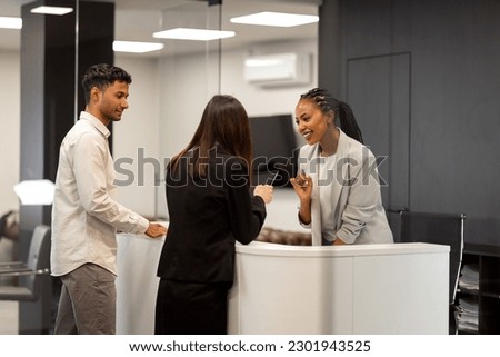 A group of multiethnic businesspeople meeting at the reception desk in the company. 