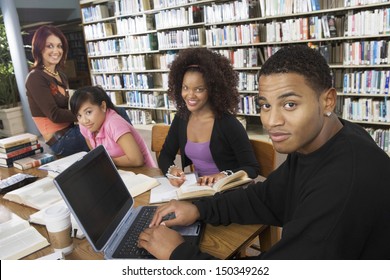 Group of multiethnic college students studying together in library