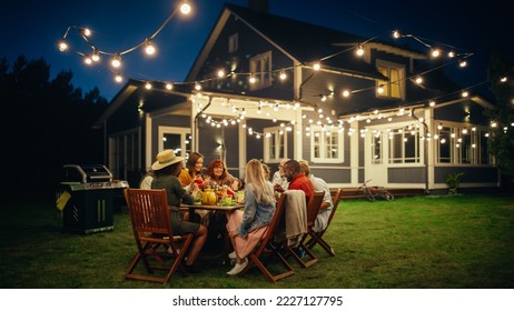 Group of Multiethnic Diverse People Having Fun, Communicating with Each Other and Eating at Outdoors Dinner. Family and Friends Gathered Outside Their Home on a Warm Summer Evening. - Shutterstock ID 2227127795
