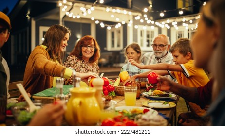 Group of Multiethnic Diverse People Having Fun, Communicating with Each Other and Eating at Outdoors Dinner. Family and Friends Gathered Outside Their Home on a Warm Summer Evening. - Shutterstock ID 2227481211