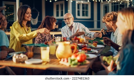 Group of Multiethnic Diverse People Having Fun, Communicating with Each Other and Eating at Outdoors Dinner. Family and Friends Gathered Outside Their Home on Warm Summer Day. - Powered by Shutterstock