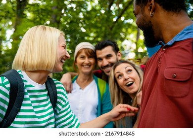 Group Of Multiethnic Friends On Hiking In Green Forest Trail. Happy Smiling Young Diverse People In Woods