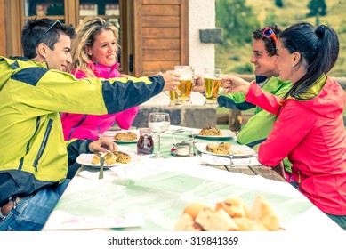 Group Of Multi-ethnic Friends Toasting Beer Glasses - Happy People Partying And Eating In Home Garden - Young Active Adults In A Restaurant On Winter Vacation
