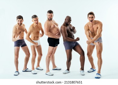 Group of multiethnic men posing for a male edition body positive beauty set. Shirtless guys with different age, and body wearing boxers underwear