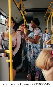 A Group Of Multiethnic People Are Riding On A Crowded City Bus