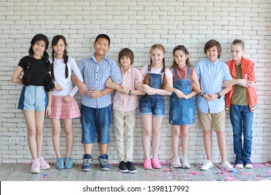 group of multiethnic school kids hands together in line in classroom with happy smiling face on white wall background (education or teamwork concept)  - Shutterstock ID 1398117992