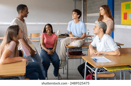 Group of multi-ethnic students talking in class during a break. High school, back to school, diverse students  - Powered by Shutterstock