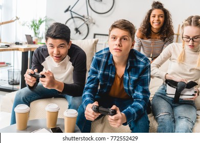 Group Of Multiethnic Teens Playing Video Game At Home