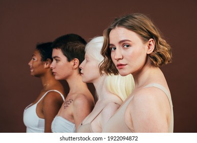 Group Of Multiethnic Women With Different Kind Of Skin Posing Together In Studio. Concept About Body Positivity And Self Acceptance