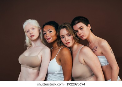 Group Of Multiethnic Women With Different Kind Of Skin Posing Together In Studio. Concept About Body Positivity And Self Acceptance