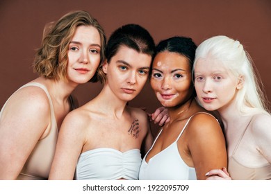 Group Of Multiethnic Women With Different Kind Of Skin Posing Together In Studio. Concept About Body Positivity And Self Acceptance