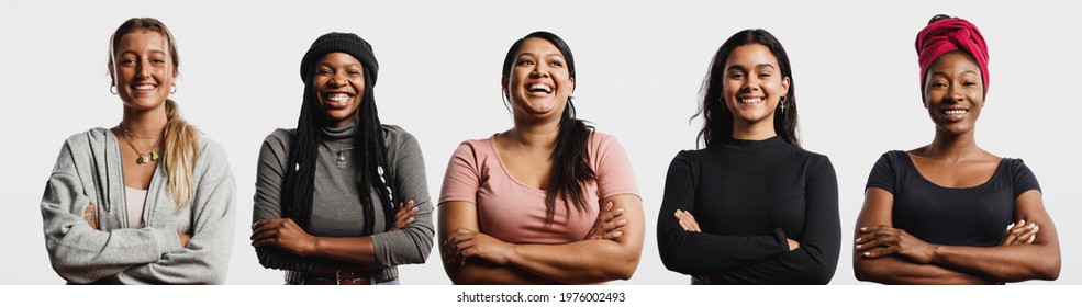 Group Of Multiethnic Women Standing On White Background. Happy Women Of Diverse Ethnicity Standing Together With Arms Crossed.