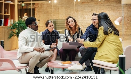 Group of Multiethnic Young People Strategizing in a Conference Room at Office. Female Supervisor Consulting her Team and Collectively Working on an Inclusivity Project. Close up