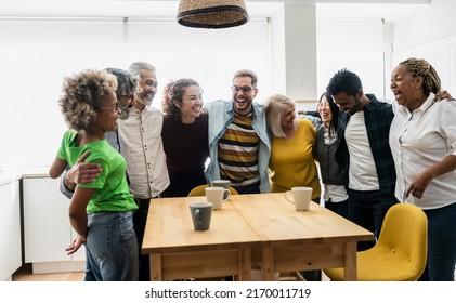 group of multigenerational friends in the kitchen at home, having the best time together - multiracial people - - Powered by Shutterstock