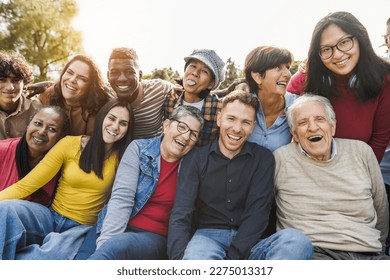 Group of multigenerational people smiling in front of camera - Multiracial friends of different ages having fun together - Main focus on caucasian senior faces - Shutterstock ID 2275013317
