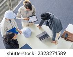 Group of multinational engineers and business people meeting in a building. International business. High angle view.