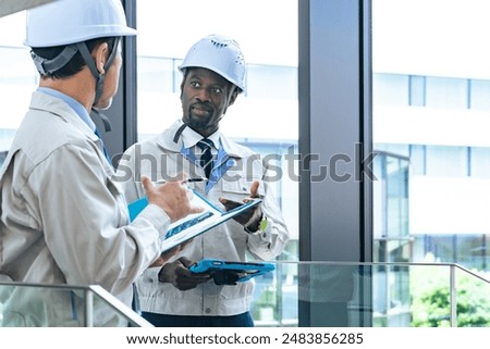 Group of multinational engineers having a conversation in a facility