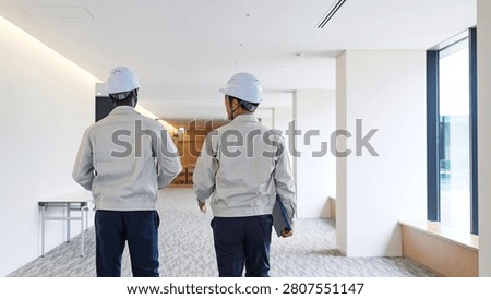 A group of multinational engineers walking through a building.