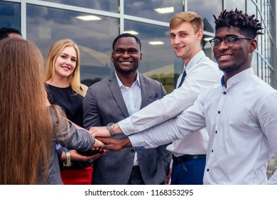 a group of multinational people businesswoman and business man at a business meeting communicating against the background of office windows on the street. teamwork concept - Shutterstock ID 1168353295