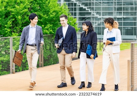 Group of multinational people walking on street. International business.