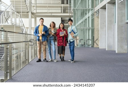 Group of multinational students smiling and lining up at university
