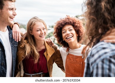 Group of multiracial best friends laughing together outdoor - Mixed race students having fun at college campus -  Friendship, tourism, community, youth and university concept.	 - Shutterstock ID 2076192034