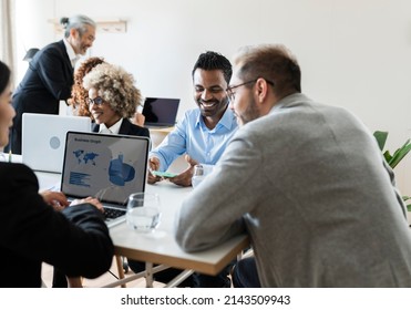 Group Of Multiracial Business Entrepreneurs Working In An Office Setting - Focus In Indian Man -