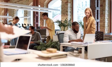 Group of multiracial business people working together in the creative co-working space. Team building concept. Office life