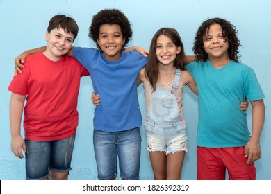 Group Of Multiracial Children Hugging Each Other. White, Black Child With Down Syndrome. Children's Day Concept