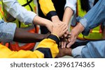 group of multiracial colleagues joining hands in morning meeting before going to work at a manufacturing industrial factory, teamwork of diverse worker stacking hands together motivate team building