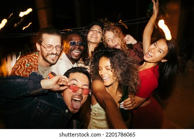 A group of multiracial friends has a great time at the roof nightclub in the summertime. Clubbing, fun, and parties during the summer concept. - Shutterstock ID 2201786065